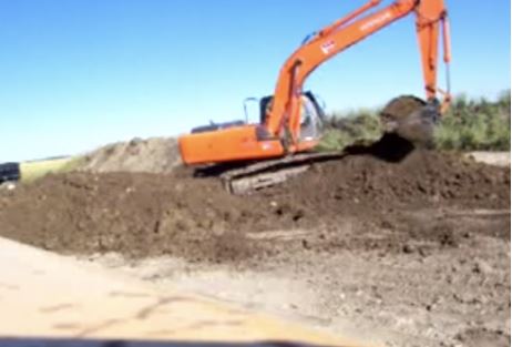 Excavator digging up dirt