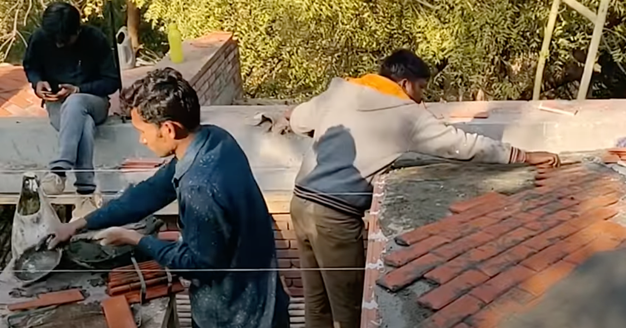 Video shot of vaulted ceiling construction and guy staring at phone